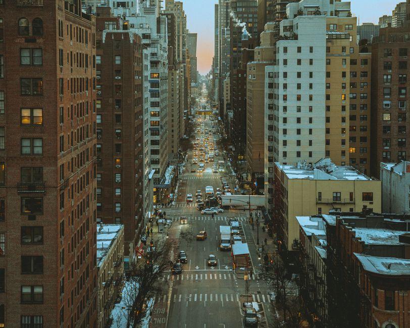 Busy Road in Between Tall Buildings